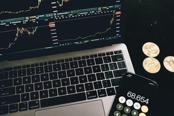 Cryptocurrency coins arranged next to a trading chart representing the exchange process